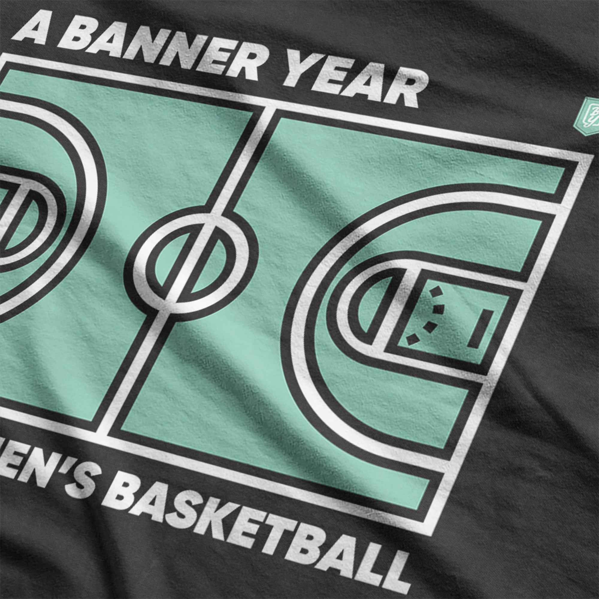 Close-up of seafoam and black Common Court women’s basketball shirt by Banner Year